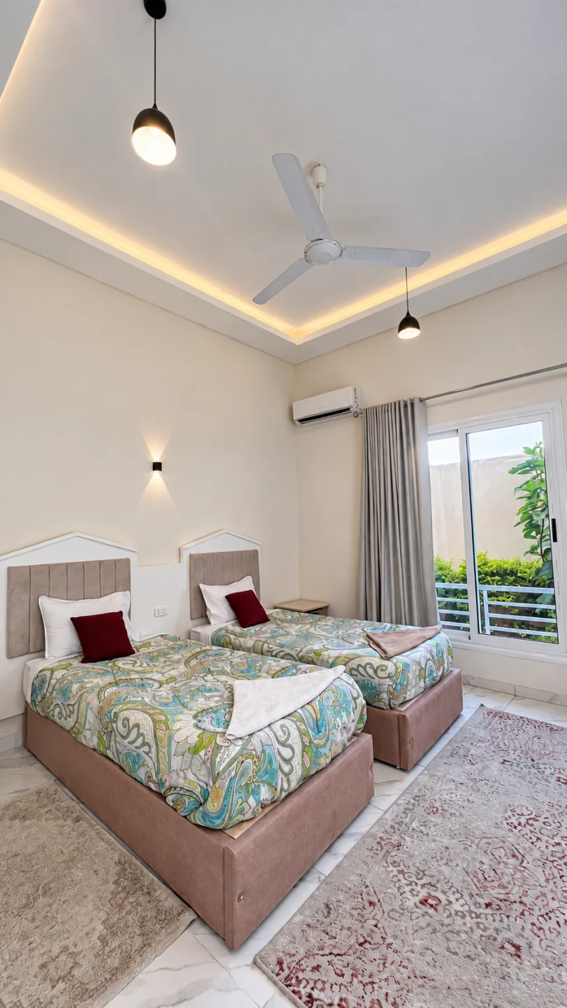 Twin beds and warm ceiling lighting