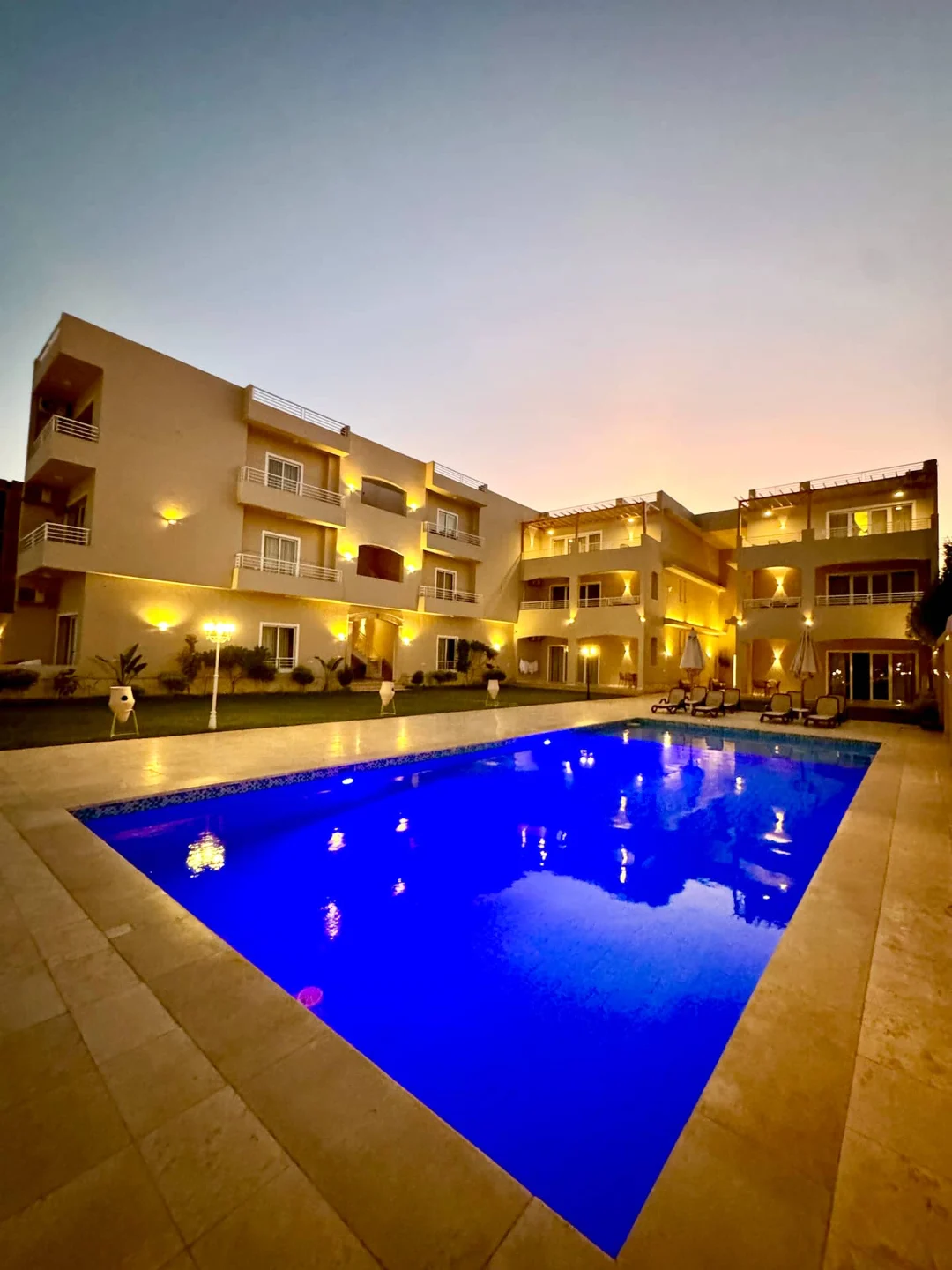 Royal Nile Villas shared pool at dusk