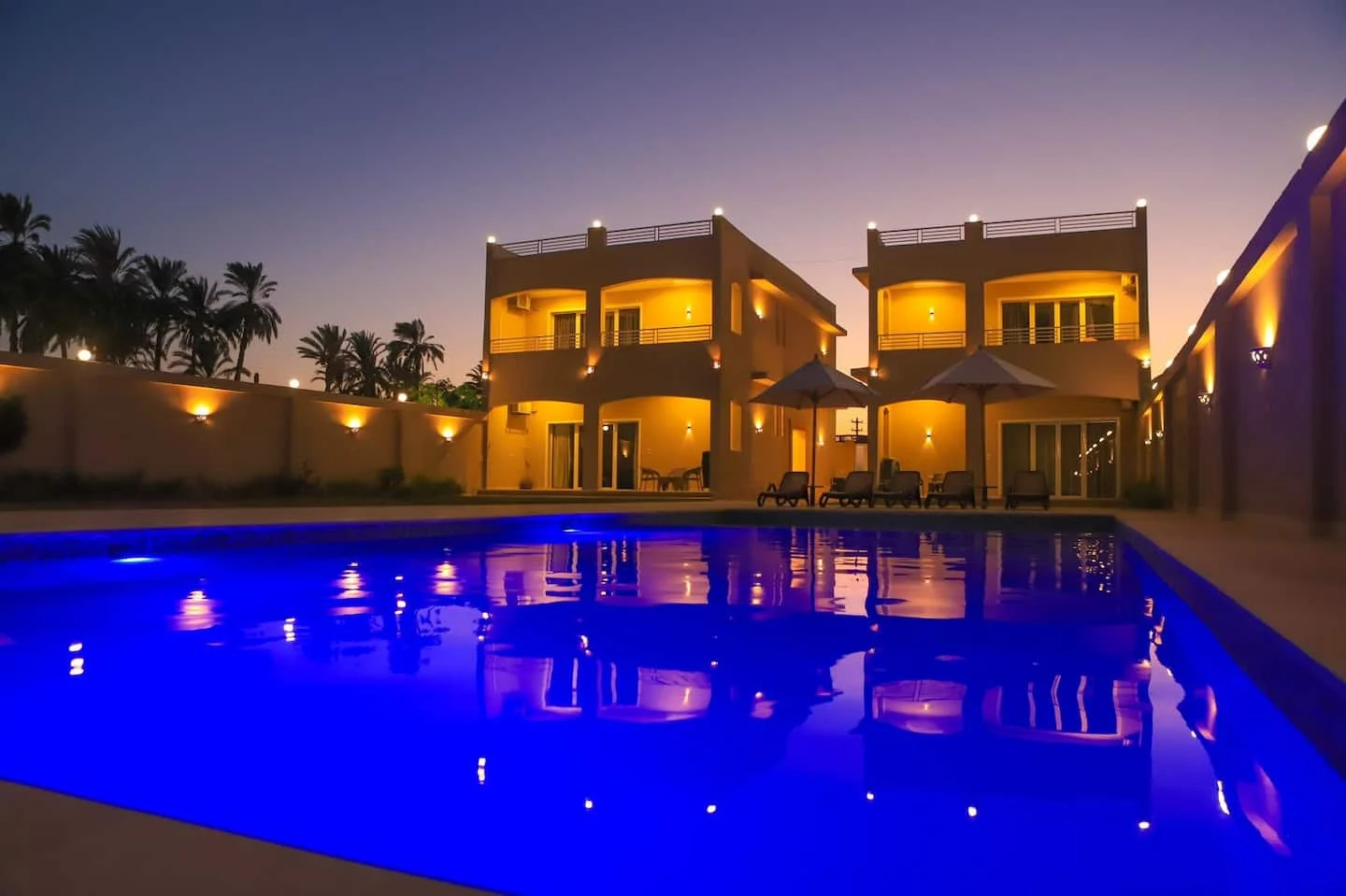 Shared pool and villa buildings at night